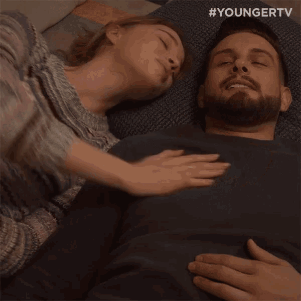 a man and a woman are laying on a bed with the hashtag youngertv