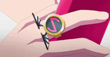 a person is wearing a ring with a letter s on it