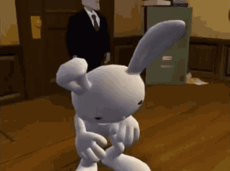 a cartoon bunny is standing on a wooden floor in front of a man in a suit and tie