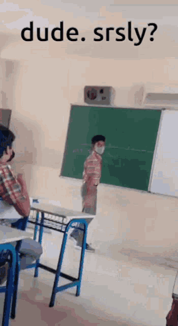 a man wearing a mask is standing in front of a blackboard with the words dude srsly written above him