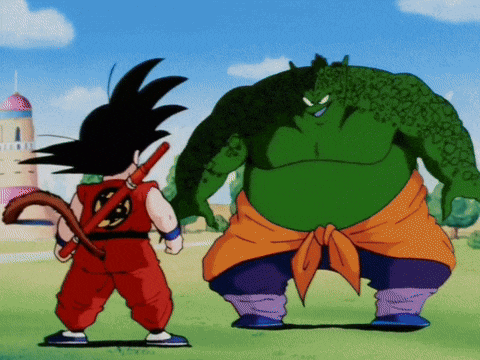 a cartoon character named goku stands next to a green monster