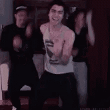 a group of young men are dancing together in a room .
