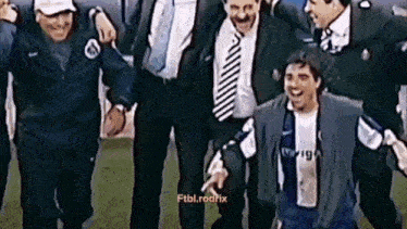 a group of men are standing around a soccer player who is wearing a nike jersey