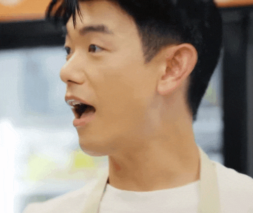 a close up of a man 's face with his mouth wide open