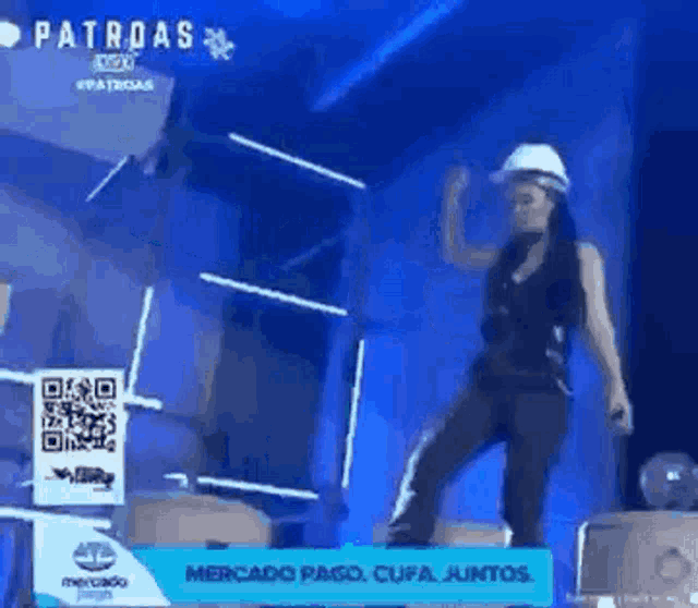 a woman in a hard hat is dancing on a stage