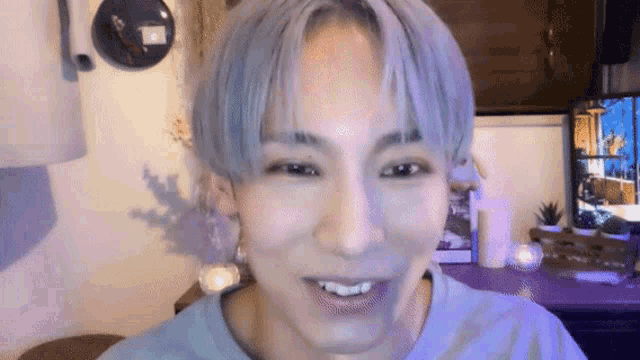a close up of a person 's face with a blue shirt on