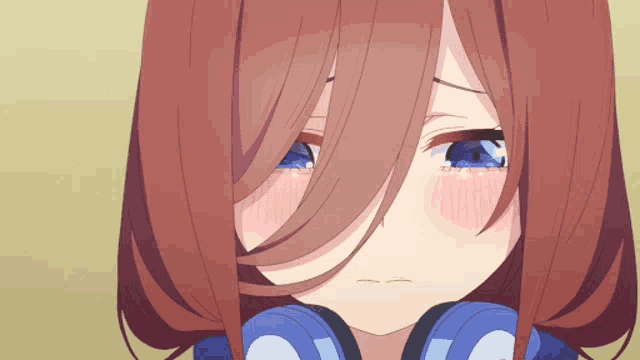 a close up of a girl with headphones on her head