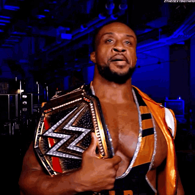 a wrestler wearing a shirt that says the day is holding a championship belt