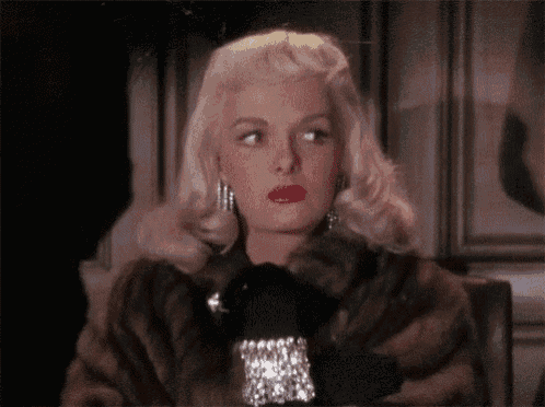 a woman wearing a fur coat and black gloves