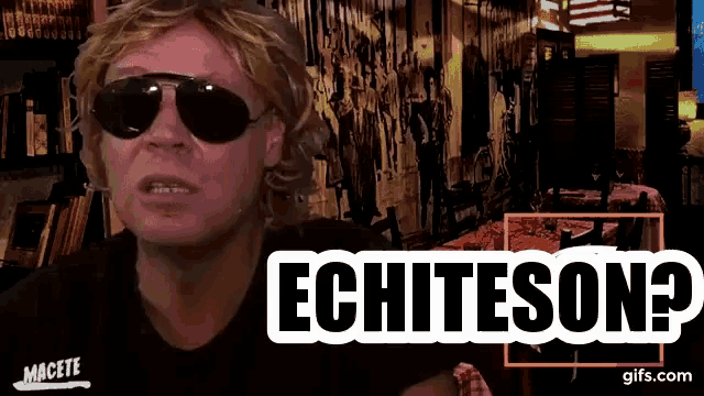 a man wearing sunglasses says echtesona in front of a bookshelf