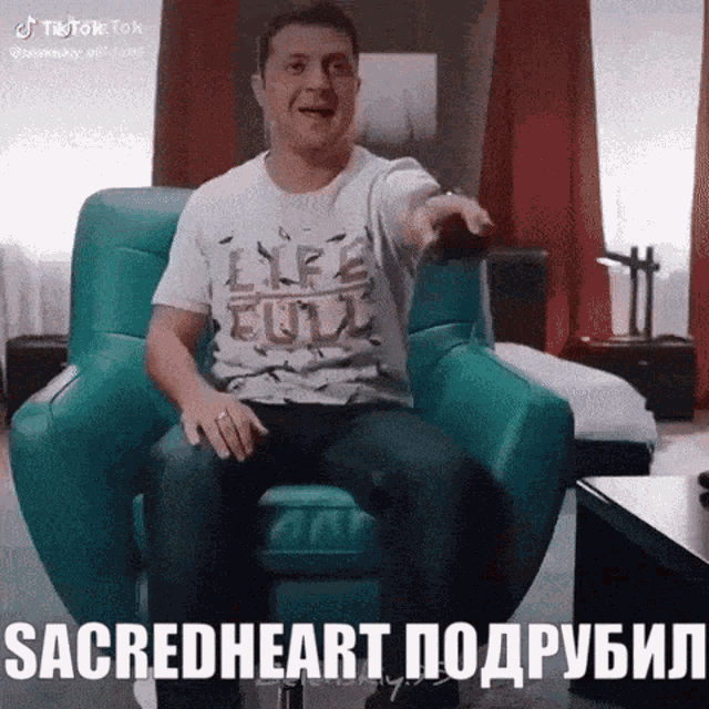 a man in a life full shirt is sitting in a chair and pointing
