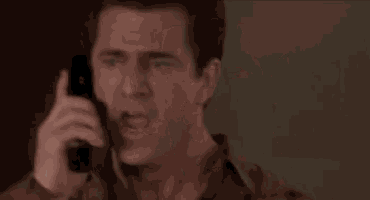 a man talking on a cell phone with the words " give me back my show " behind him