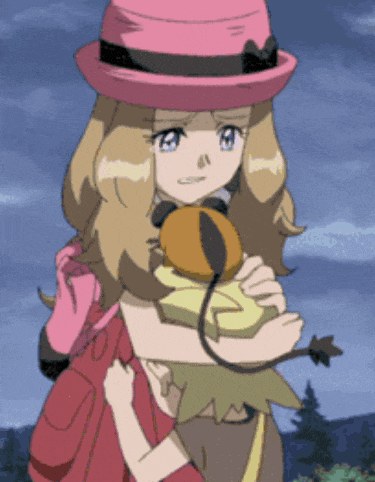 a girl in a pink hat is holding a small child in her arms