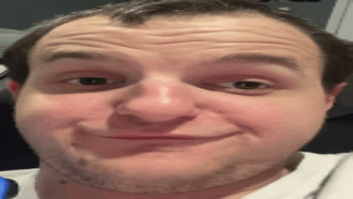 a man with a beard is making a funny face