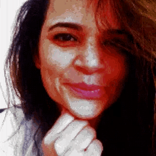 a pixelated image of a woman 's face with a hand on her chin