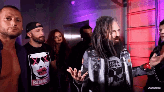 a man with dreadlocks is wearing a shirt that says " bennet "