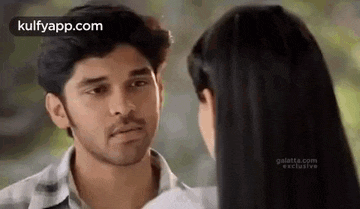 a man and a woman are looking at each other and talking .