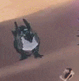 a dragon is sitting on top of a sand dune .