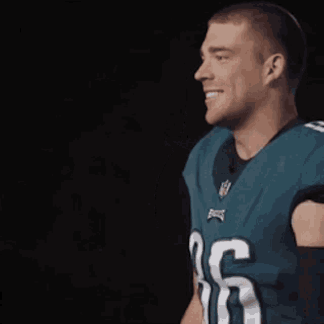 a man wearing a green jersey with the number 26 on it