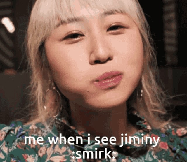 a close up of a woman 's face with the words me when i see jiminy smirk