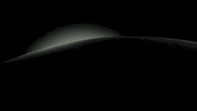 a black and white image of a planet with a light coming out of it .