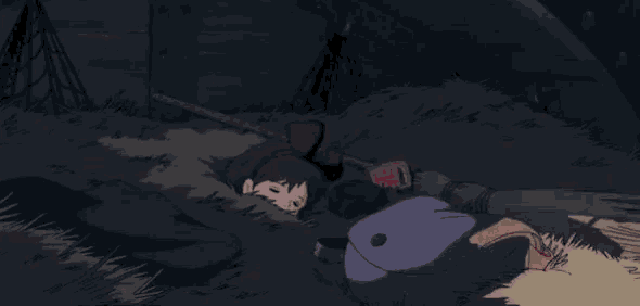 a girl with a bow on her head is laying on the ground .