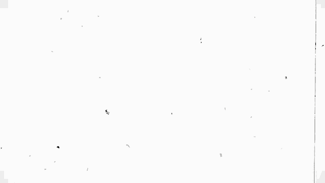 a close up of a white wall with a few spots on it