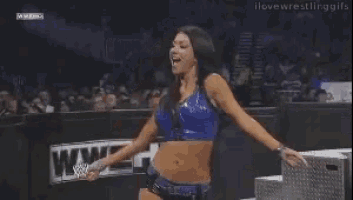 a woman is standing in front of a sign that says wwe hd .