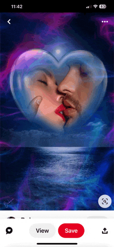 a phone screen shows a picture of a man and woman kissing inside of a heart shaped bubble