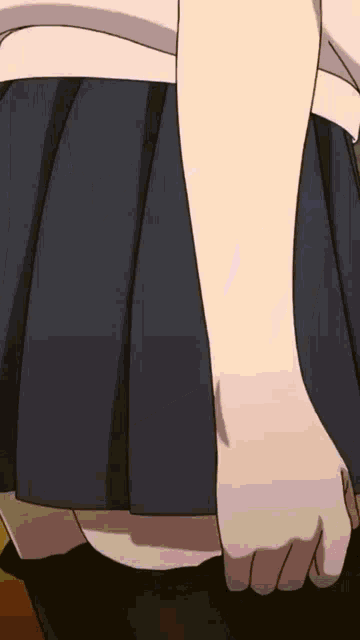 a close up of a person 's hand holding a black skirt .