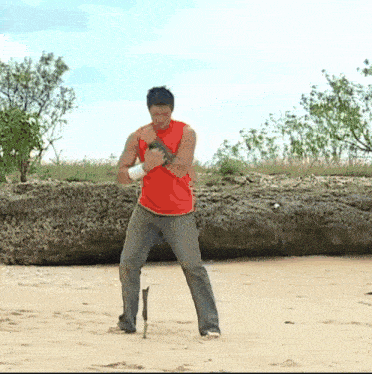 a man with a prosthetic leg is standing on a beach