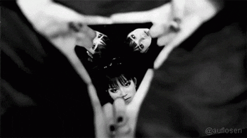 a black and white photo of people making a triangle