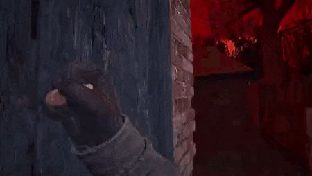 a person is holding a piece of bread in their hand in front of a brick wall in a video game .