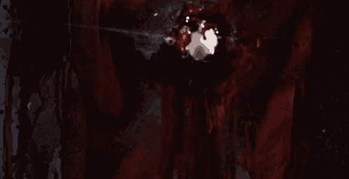 a close up of a bloody object with a white object in it
