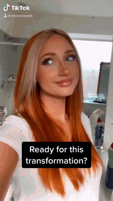 a woman with red hair is taking a selfie in a bathroom with the caption ready for this transformation