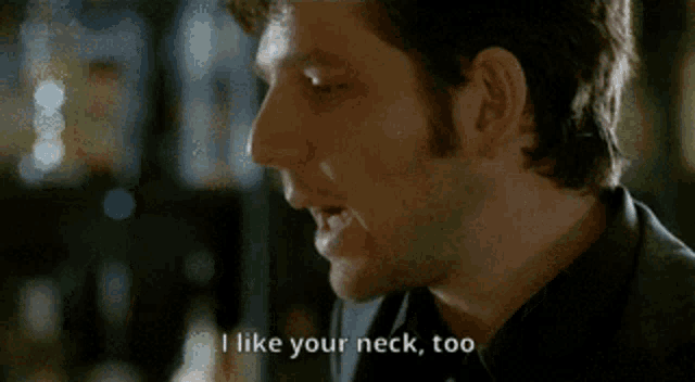 a man and woman are looking at each other and the woman says i like your neck too