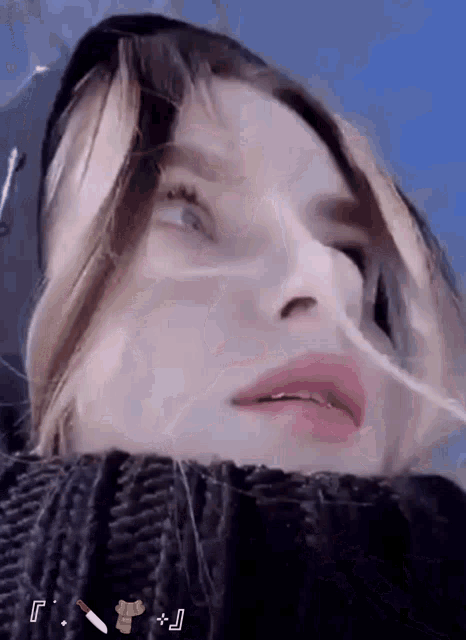a close up of a woman 's face with the letters f and j in the corner