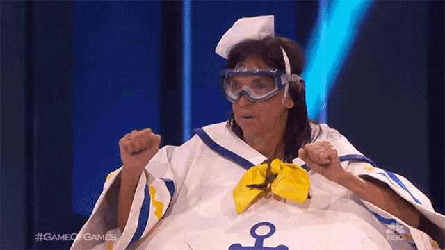 a woman in a sailor costume with a yellow bow and goggles on a game of games show