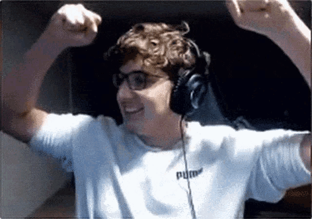 a man wearing headphones and a white shirt with puma on it
