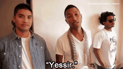 three men are standing next to each other and one of them is wearing a bullet belt around his neck and says yessir