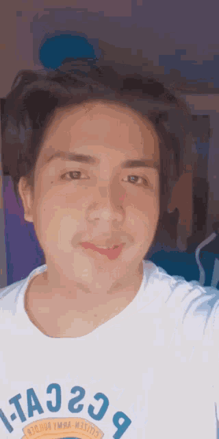 a man wearing a white t-shirt with the letters ta23 on it