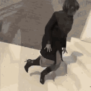 a woman is walking down a set of stairs wearing high heels .