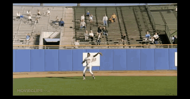 a baseball player on a field with a minnesota twins sign