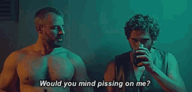 two shirtless men are standing next to each other drinking beer and talking .