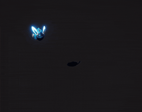 a glowing object in the dark with a yellow beam coming out of it