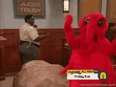 a red monster is standing in front of a sign that says judge trudy on it