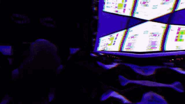 a man wearing headphones is looking at a computer screen which says ' a ' on it