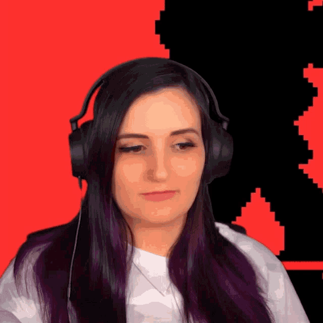 a woman with purple hair is wearing headphones in front of a pixelated background