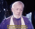 a man with a beard and a scarf is talking to someone in a dark room .