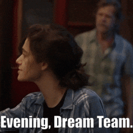 a man in a plaid shirt stands in a crowd with the words evening dream team written below him